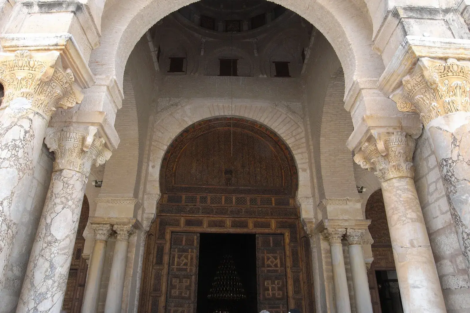 The Great Mosque of Kairouan, with its massive square minaret and sunlit courtyard