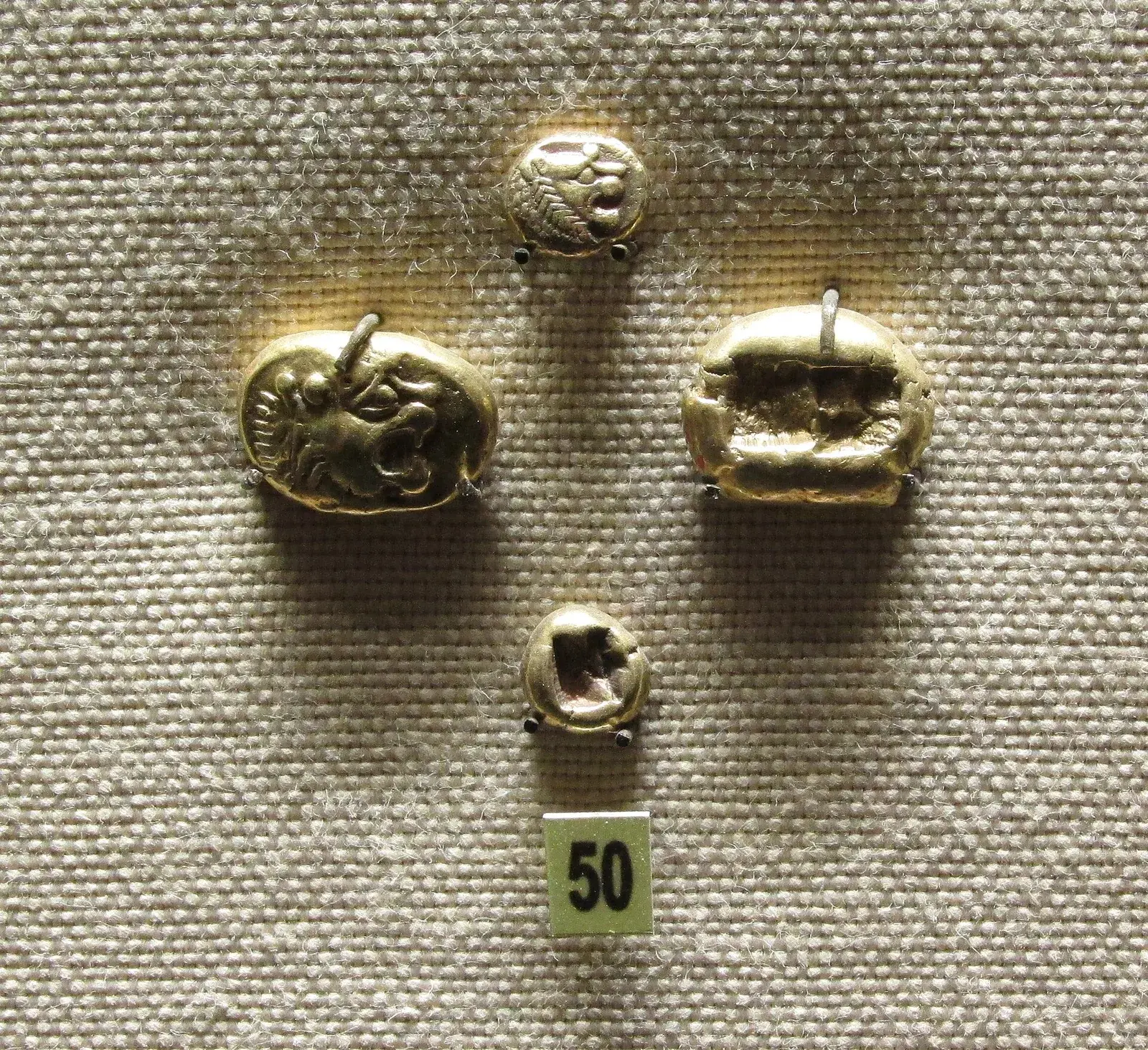 A small Lydian electrum coin stamped with the head of a lion
