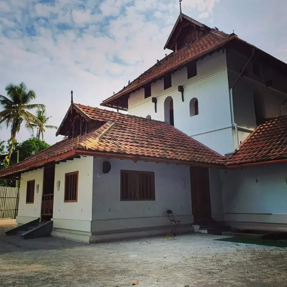 An old coastal mosque in Kerala with a tiled sloping roof in a South Indian architectural style