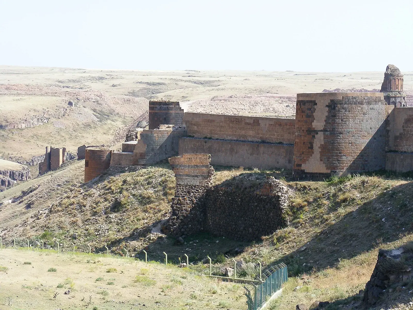 Ruined medieval walls and churches of Ani, the former Armenian capital, on a grassy plateau