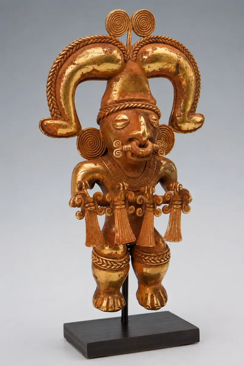 A small gold tumbaga tunjo figurine cast using the lost-wax method by Tairona goldsmiths