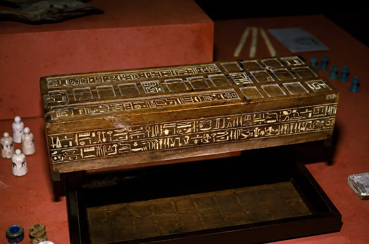 An ancient Egyptian Senet board with carved playing pieces, one of the oldest known board games