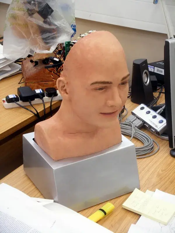 A close-up of a highly realistic humanoid robot face with lifelike skin and eyes